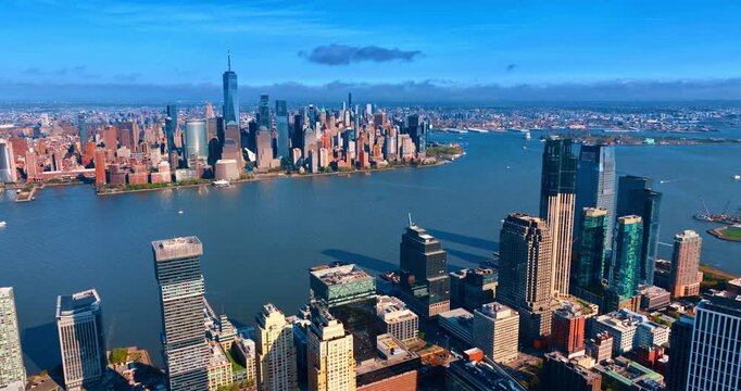 Jersey City Aerial View Toward Lower Manhattan Skyline. Aerial view of Jersey City waterfront, Hudson River, and Lower Manhattan skyline under blue sky.