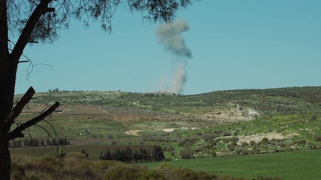 A smoke of an explosion is visible above an evacuated village in Southern Lebanon, where the  IDF is attacking a Hezbollah guerilla group. the shot was taken right after the explosion.