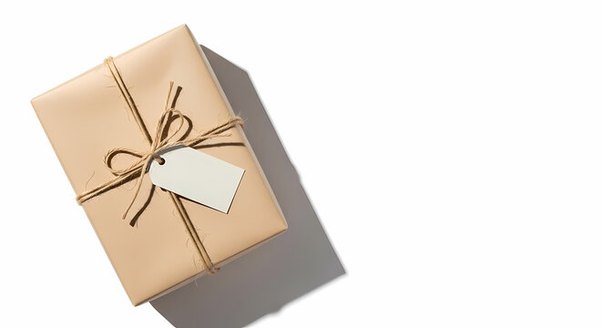 A simple brown paper gift box is tied with twine and features a blank tag on a clean white background.