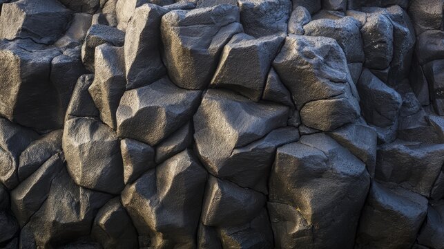 igneous. Black basalt rock formation with intricate crack patterns, volcanic texture. travel magazines, destination branding, designed for travel destination branding, used by food bloggers.
