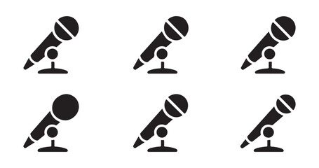 Dynamic handheld microphone icons on desk stands for conference speaking and interview recording applications. © Masudur