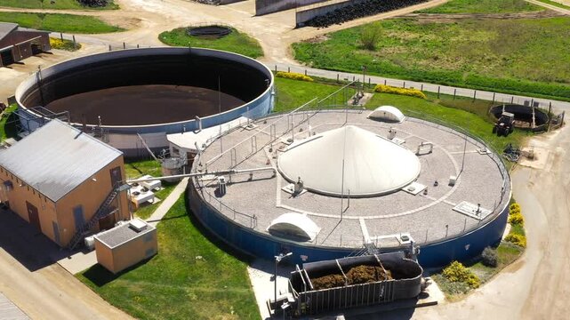 Biogas plant and farm in fields. Renewable energy from biomass. Aerial view to Czech industry. Sustainable development in European Union.