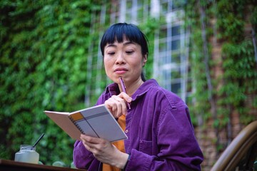 Fototapeta premium Creative woman working with notebook in nature