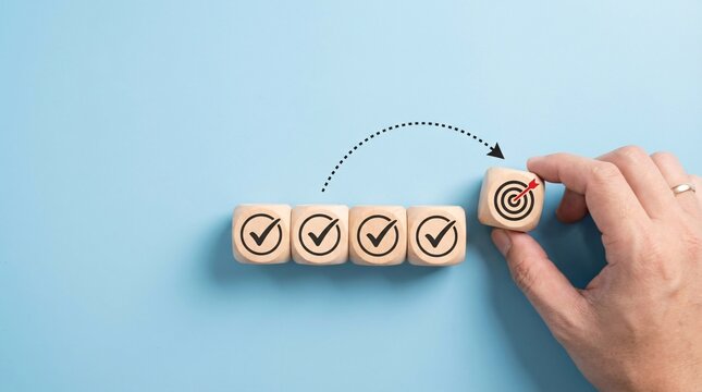 Hand placing target cube on row of checkmark cubes symbolizing achieving goals completing tasks and reaching objectives with strategic planning and successful execution in a bright