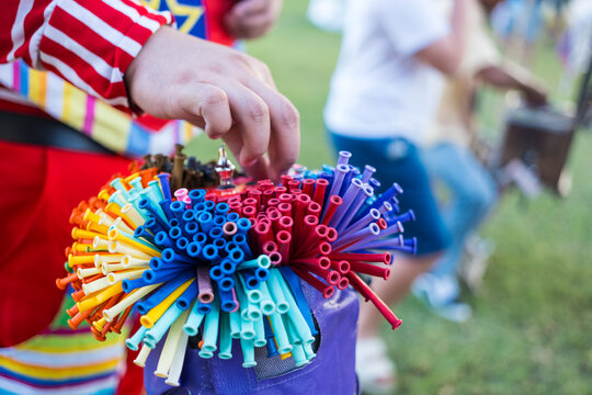 Close up of a freelance making twist balloons for kids