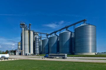 Grain silos serve as critical transportation hubs allowing for the seamless transfer of grain from farms to trucks, trains, and ships. © photogrfx
