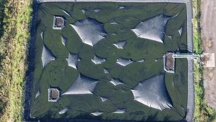 Covered biomass storage bunker in rural landscape. © Maik