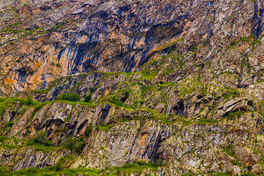 Close-up of rocky mountain slope with green vegetation