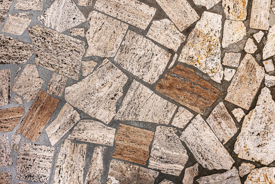Palladiana or opus incertum flooring made from irregular fragments of natural stone, travertine, or limestone; textured background