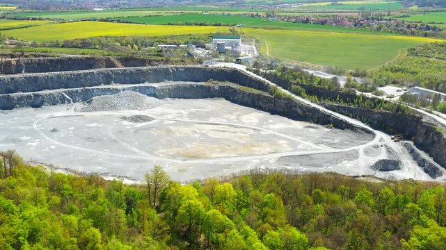 Stone quarry. Open cast mining. Industrial landscape. Heavy industry from above. Aerial view to big source of emissions.