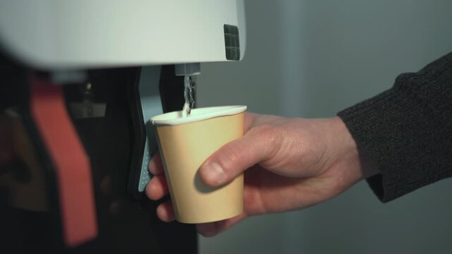 Coffee Break Moment. Employee Refills Disposable Cup With Hot Coffee In Morning Office Environment. Media