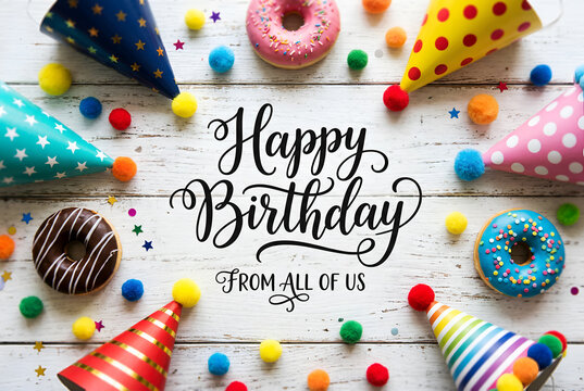 Happy birthday from all of us with donuts, party hats and colorful pom poms