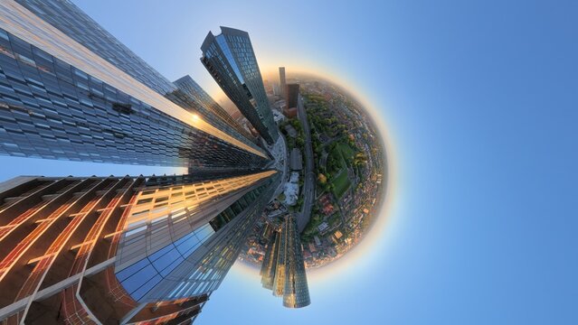 Creative 360 tiny planet panorama of modern Manchester residential towers at sunrise