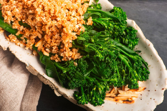 Blanched Bimi Broccoli with Toasted Almonds, Butter and Breadcrumbs on Handmade Ceramic Plate