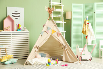 Cute wigwam and toys in stylish child's room © New Africa