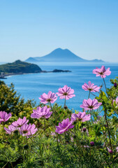 Obraz premium Mountains and wildflowers by the sea under clear blue sky