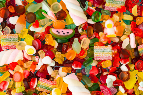 Creative background of gummy candies. Minimal trendy gummies concept. Jelly sweets aesthetic. Colorful flat lay. Top view.