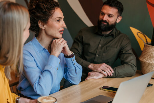 Colleagues collaborating and discussing ideas during a business meeting