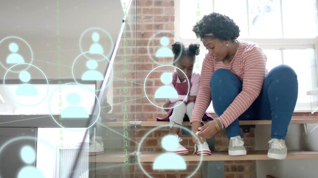 Mom reaching and tying child lace, securing shoe while tech user-icons drifting over subjects