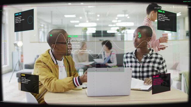 Man gesturing at laptop triggers HUD showing finance graph, woman tapping notebook aligning plan