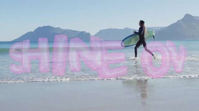 Sportsman running from shore into sea with board, pink SHINE ON overlay guiding deeper surf entry