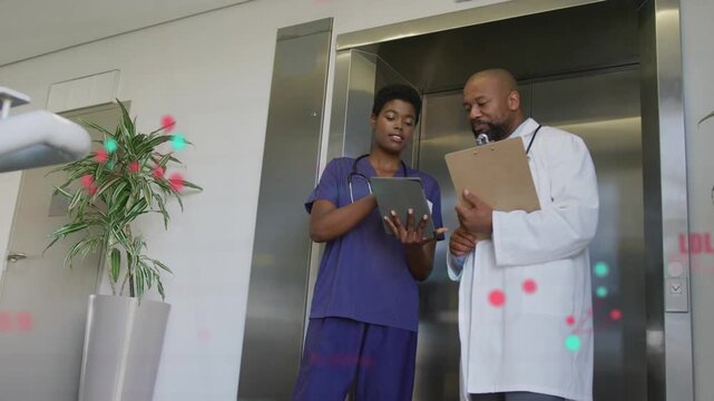 Nurse tapping tablet and doctor reviewing clipboard, particles marking patient data around tablet