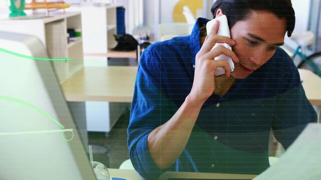 Designer answering call while checking tablet, confirming design, green waveform overlaying screen