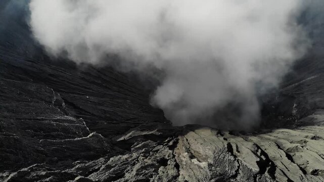 Drone Panning Right Above Mount Bromo Crater with Volcanic Smoke, Java, Indonesia