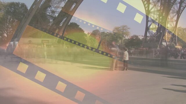 Filmstrip overlay sliding across plaza, flare sweeping, crowd pausing and shooting, evoking travel