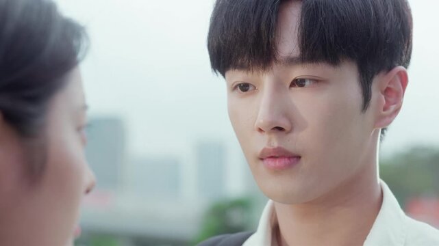 Romantic young asian man holding a bouquet of flowers looking at his girlfriend during a date
