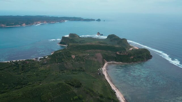 Aerial Reef Lagoon With Long Sheltered Bay, Clear Shallow Flats And Turquoise Channels, Gentle Breakers Along Outer Reef, Narrow Sandy Shoreline, Katil beach,Kuta,Lombok,Indonesia