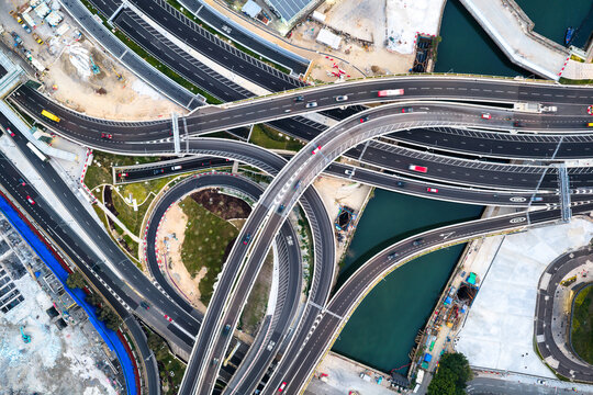 An aerial top down view of a complex multi level highway interchange in Hong Kong showcasing modern urban infrastructure and efficient traffic flow.