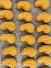 Fototapeta premium freshly baked nuggets on a baking sheet for the oven.
