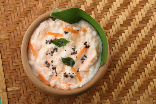 Carrot Curd rice served in a banana leaf and earthen pot