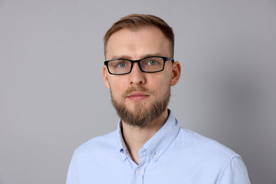 Portrait of handsome man in shirt on light grey background