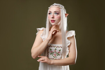 Naklejka premium Beautiful elf girl on dark olive background