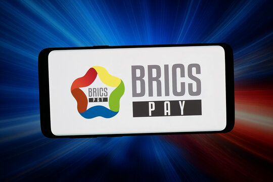 Stuttgart, Germany - 04-23-2026: In this photo illustration, the logo of payment system BRICS Pay is displayed on a smartphone in front of abstract background on computer screen.