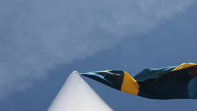 Stockholm, Sweden A large Swedish flag flies on a flagpole. 