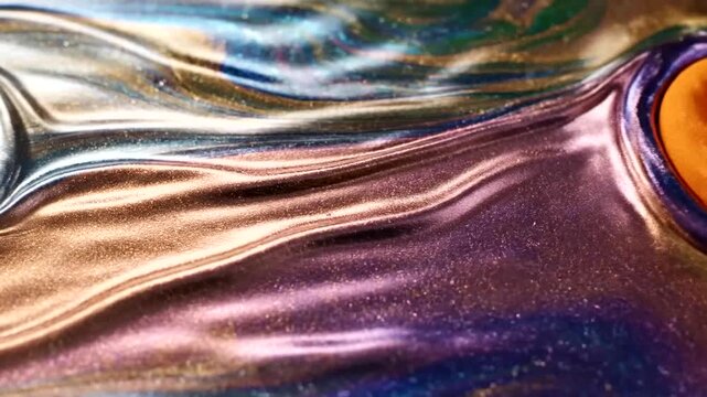 Multicolored liquid swirling together closely.