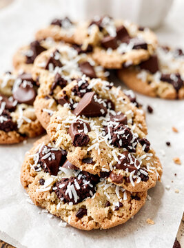 A delicious assortment of homemade cookies topped with rich chocolate chips and shredded coconut. Perfect for a cozy dessert or an afternoon snack.