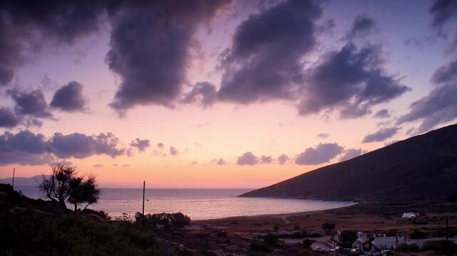 Breathtaking view of a colourful sunrise at the Theodoti beach in Ios Greece