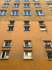 Fototapeta premium Two-Tone Apartment Building Facade with Symmetrical Windows