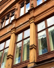 Obraz premium Weathered Vintage European Building Facade with Ornate Windows