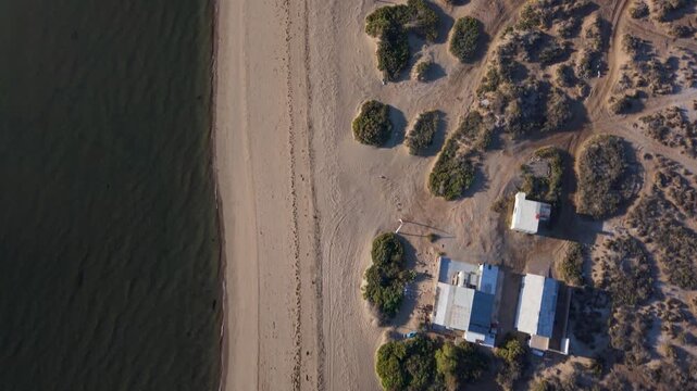 Sunrise lights up Bahia De Los Angeles in Baja California Mexico while showing beach spots and camping areas from above.