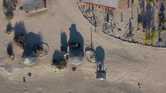 Aerial views capture sunrise over Bahia De Los Angeles in Baja California. The area features camping, beach, and simple structures.