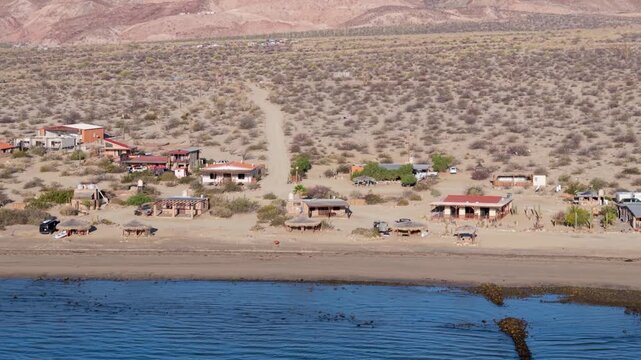 Aerial shots capture the sunrise over Bahia De Los Angeles, highlighting the beach and camping areas along the shore.