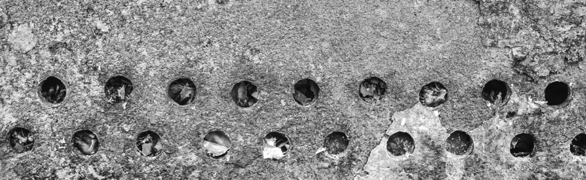 Texture old weathered worn messy obsolete dirty barbecue round gray holes pattern abstract