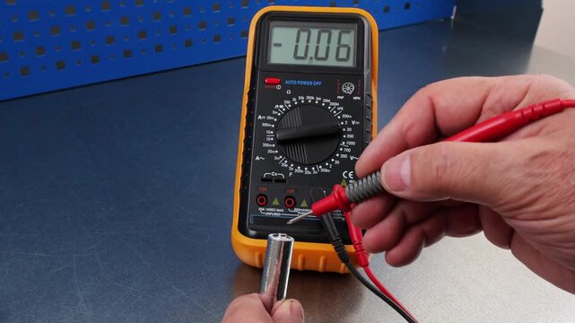 Measuring the voltage of alkaline batteries using a digital multimeter.
