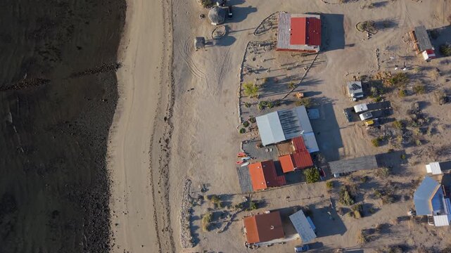 Watch as sunrise lights up Bahia De Los Angeles in Baja California, featuring views of the beach and camping areas by the shore.