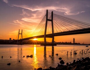 Obraz premium Modern cable bridge at sunset over water